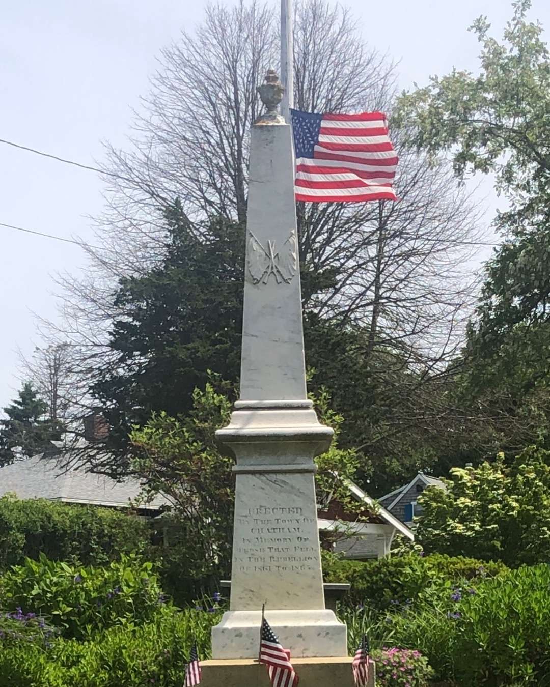 American flag behind statue